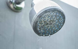 what causes low water pressure in shower